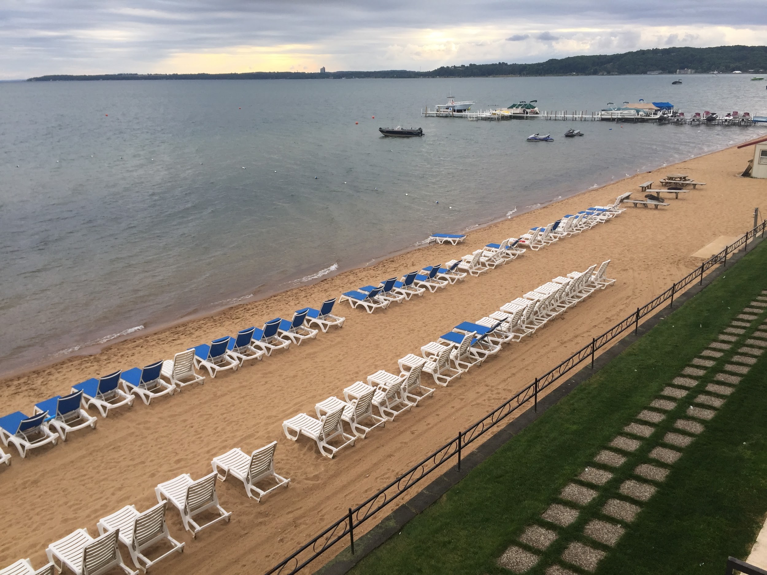 empty beach chairs lined up on Traverse City sandy beach