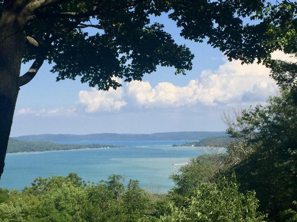 scenic view of Lake Michigan water and shoreline with forested hills